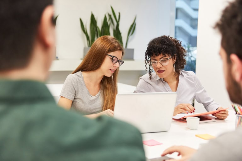 Two women reviewing an older website in regard to digital transformation