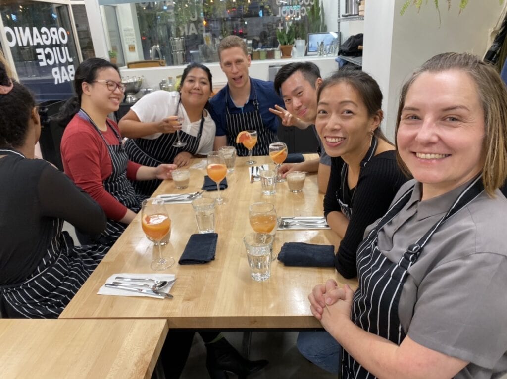 Photo of OXD staff with drinks sitting at a table.