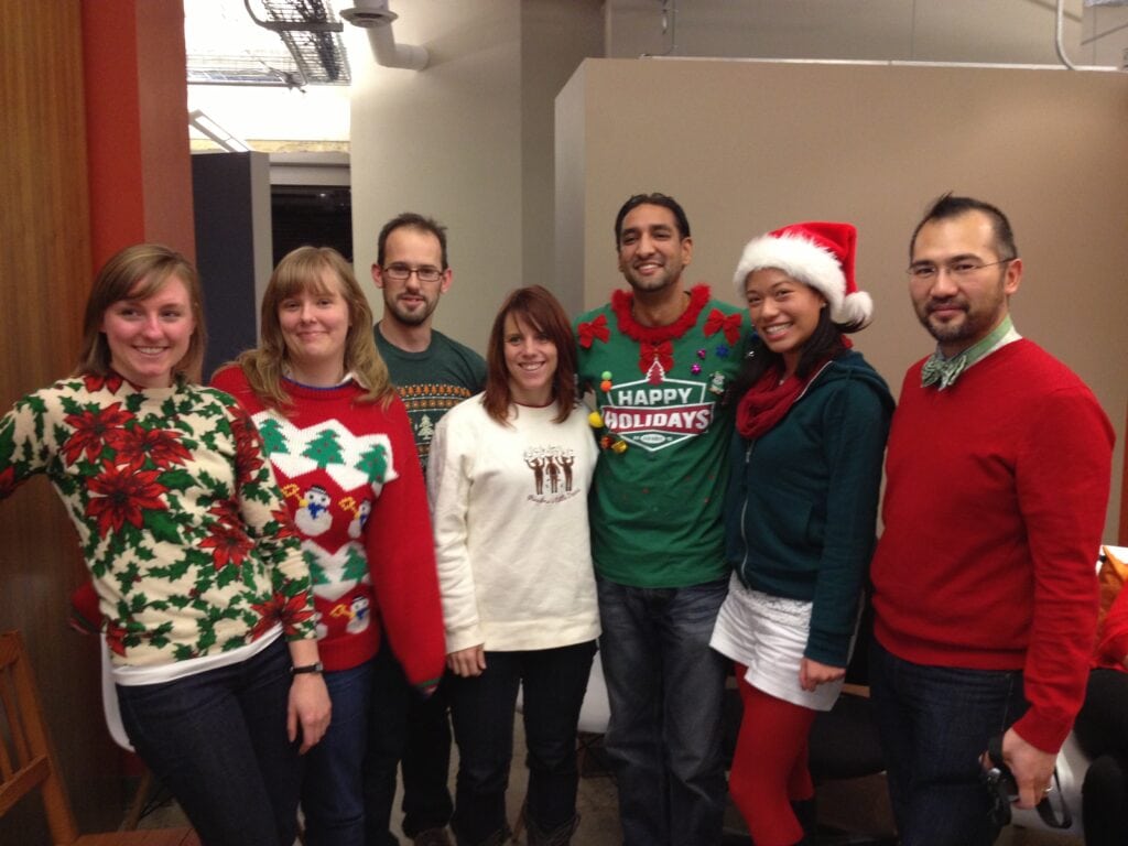 Holiday staff photo in ugly Christmas sweaters