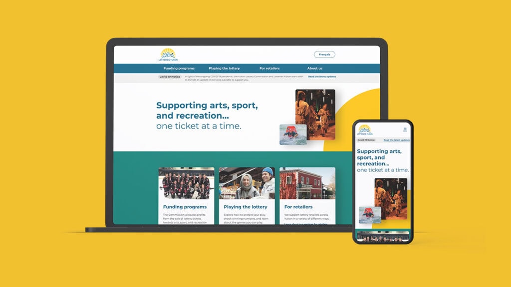 Lotteries Yukon redesign website home page on a clay laptop and iphone over a gold background