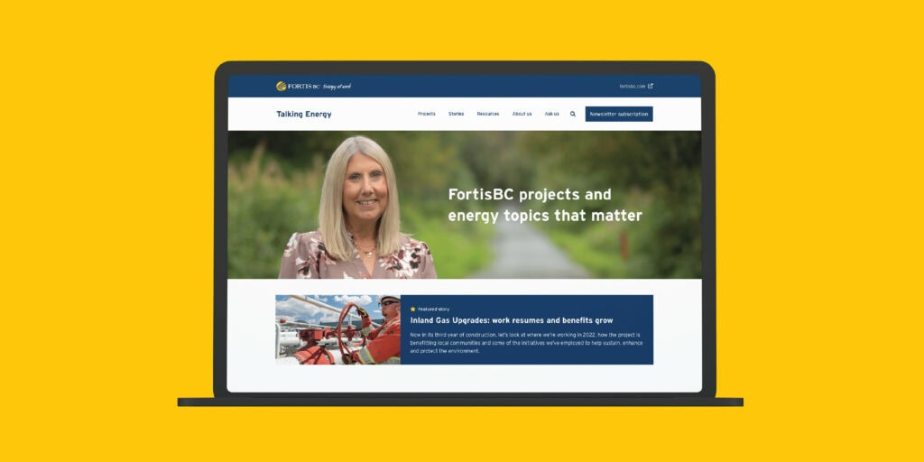 Talking Energy website home page screenshot on a clay laptop over a yellow background